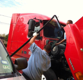 Man changing truck front glass